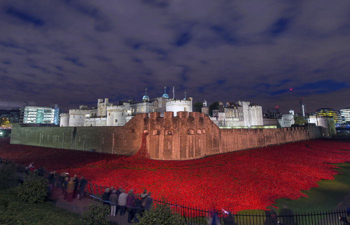 The Tower of London with the evolving art installation 'Blood Swept Lands and Seas of Red'. The major art installation named Blood Swept Lands and Seas of Red consists of 888,246 handmade ceramic poppies, each poppy representing a British fatality during World War I and created by ceramic artist Paul Cummins and stage designer Tom Piper.